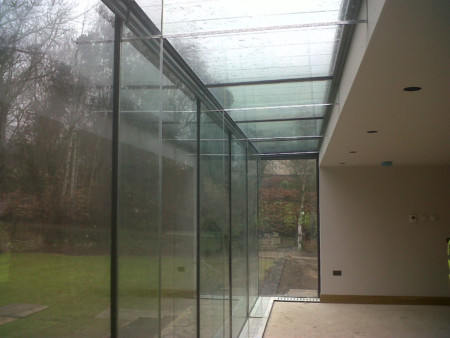 Frameless glass box with glass fins and beams.