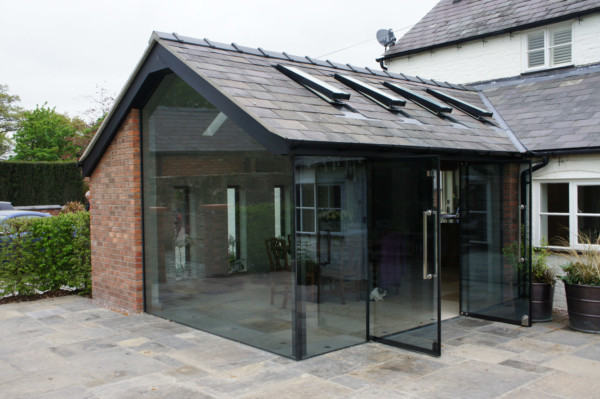 Frameless glass floor to ceiling with large gable glazed panel.