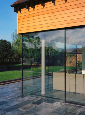 Structural glazing with frameless glass doors.