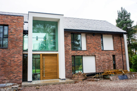 Fixed structural glass and oak bifolding doors.