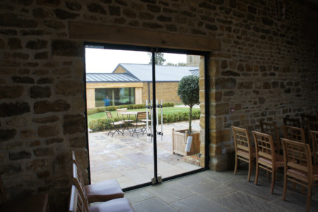 Structural glazing with frameless glass doors and Sky-frame sliding doors.